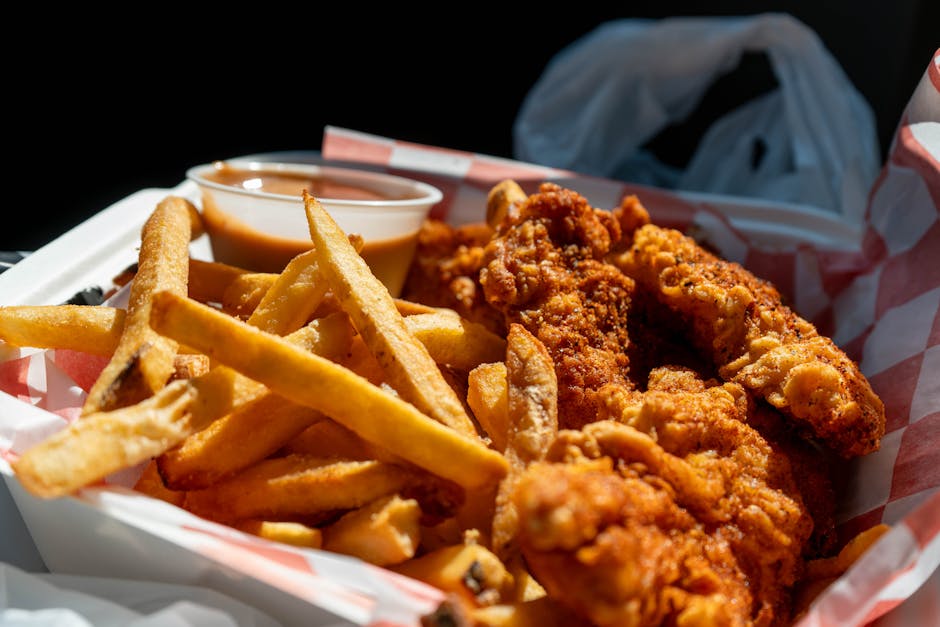 Delicious serving of crispy fried chicken with fries and dipping sauce in Holland, Michigan