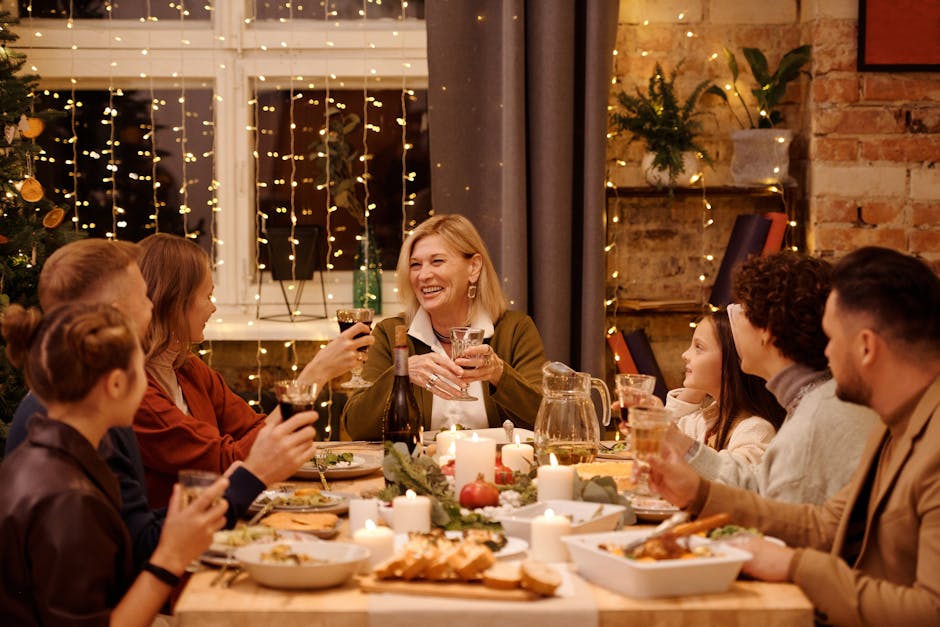 A joyful family gathering around a festive Christmas dinner table indoors, full of smiles and holiday cheer