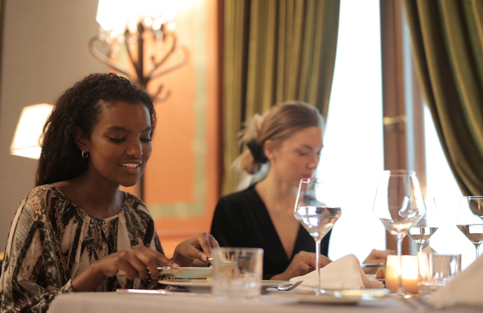 Two women enjoying a refined dining experience in a stylish restaurant setting