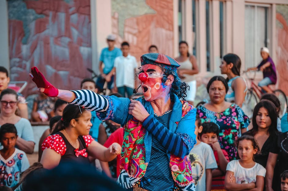 A vibrant clown performing on the street captivates a diverse audience.