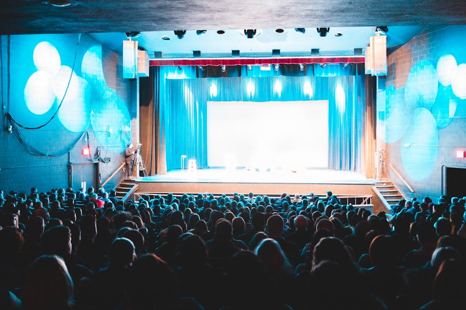 A lively theater scene with a captivated audience under bright lights, creating an immersive experience.
